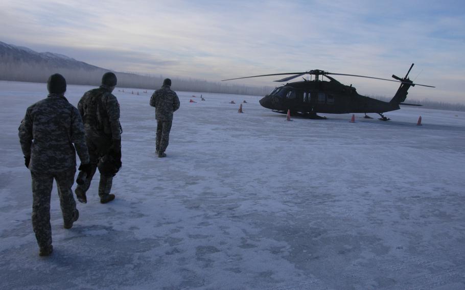 Members of the Alaska Army National Guard prepare for an early morning mission out of Fort Richardson, Alaska on Feb. 13, 2015.