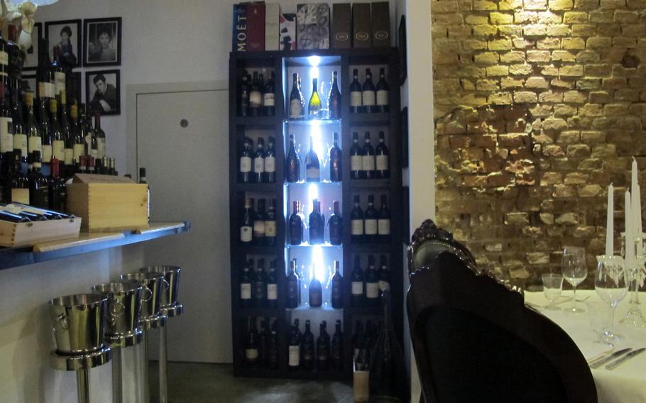 Candles, chandeliers, blue lights, exposed brick walls and photographs of Princess Diana, Tom Cruise and other celebrities make for a glowing, gorgeous ambience at tira tardi in Vicenza, Italy.