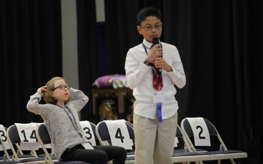 Grafenwohr Elementary School fourth-grader Ella Scheuermann reacts after Naples sixth-grader Ryan Rayos properly spells a word Saturday, March 21, 2015, at the European PTA Spelling Bee at Ramstein Elementary School in Germany.