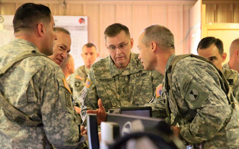 Lt. Gen. Stephen R. Lanza, I Corps commander, second from left, and Maj. Gen. Terry Ferrell, 7th Infantry Division commander, center, are briefed by Task Force Bayonet leaders at the Joint Operations Center at Fort Polk. La., on Feb. 13, 2015, during a training exercise. The task force, made up of about 50 soldiers from 7th Infantry Division and a dozen from 2nd Brigade Combat Team, will leave later this spring for a yearlong deployment to Kandahar Airfield, Afghanistan.