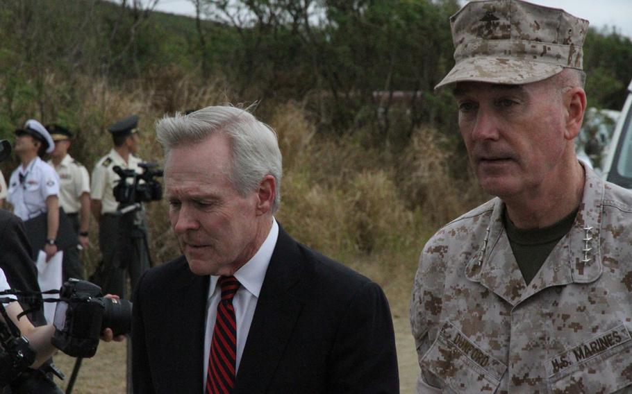 Secretary of the Navy Ray Mabus, left, and Marine Corps commandant Gen. Joseph Dunford Jr. arrive at the ceremony March 21, 2015 commemorating the 70th anniversary of the Battle of Iwo Jima. 
                