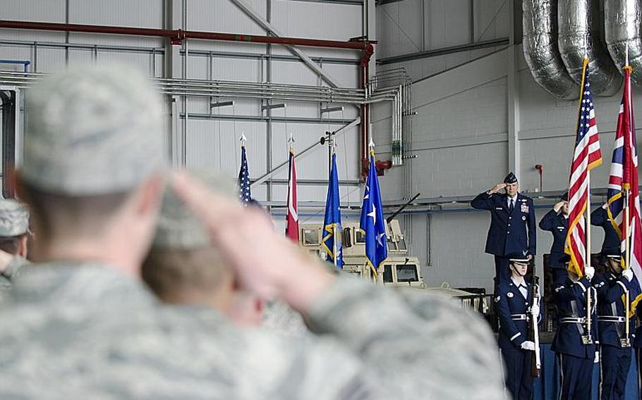 Lt. Gen. Bradley A. Heithold, commander of Air Force Special Operations, members of the audience salute during the opening of an activation ceremony at RAF Mildenhall, England, on Monday, March 23, 2015. The ceremony marked the deactivation of the 352nd Special Operations Group and its subsequent reactivation as a wing. Adam L. Mathis/Stars and Stripes