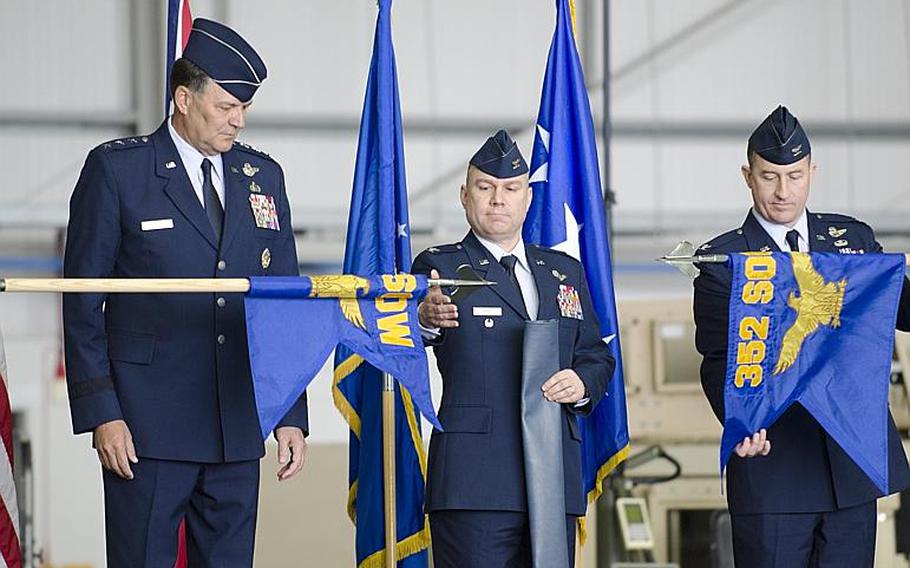 Lt. Gen. Bradley A. Heithold, commander of Air Force Special Operations, left, and Col. William G. Holt II, center, oversee the unfurlling of the 352nd Special Operations Wing flag, while Col. Nathan C. Green retires the 352nd Special Operations Group flag at RAF Mildenhall, England, on Monday, March 23, 2015. The 352nd has grown in the past few years from about 600 to about 1,200 airmen. Adam L. Mathis/Stars and Stripes