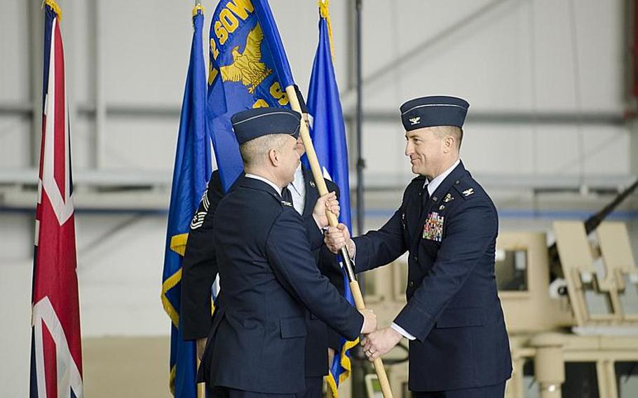 Col. William G. Holt II, commander of the 352nd Special Operations Wing, left, passes the flag for the 752nd Special Operations Group to Col. Nathan C. Green during an activation ceremony at RAF Mildenhall, England, on Monday, March 23, 2015. The ceremony marked the transformation of the 352nd Special Operations into a wing. Adam L. Mathis/Stars and Stripes