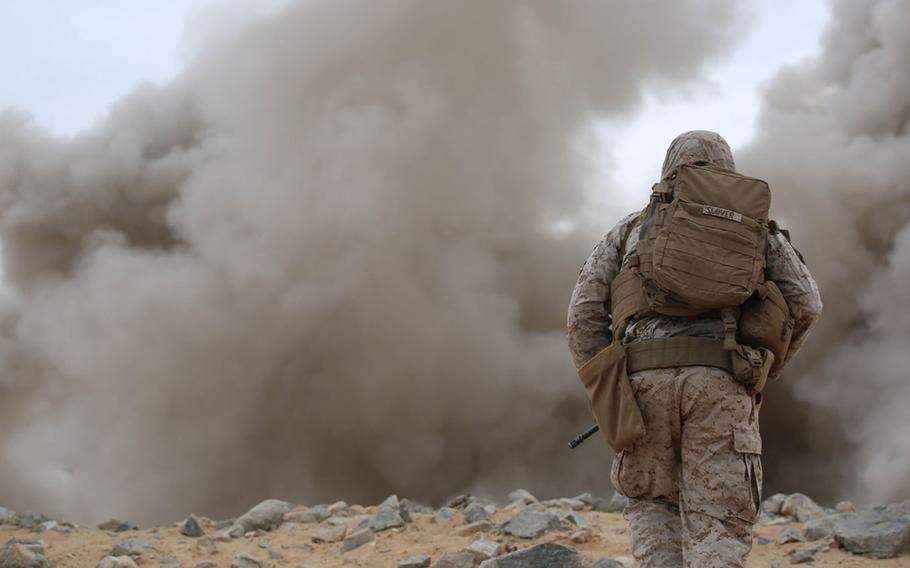 Sgt. Brenton A. Slover, squad leader, Engineer Platoon, Headquarters and Service Company, Ground Combat Element Integrated Task Force, observes the detonation of M1A2 Bangalores during a Marine Corps Operational Test and Evaluation Activity assessment at Range 107, Marine Corps Air Ground Combat Center Twentynine Palms, California, on March 22, 2015.