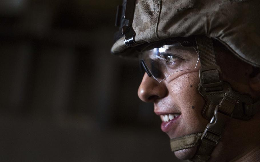 U.S. Marine Lance Cpl. Andres Bravo loads onto an AAV-7A1 Assault Amphibious Vehicle before a mechanized raid as part Composite Training Unit Exerciseaboard the USS Rushmore off the coast of San Diego on March 24, 2015.