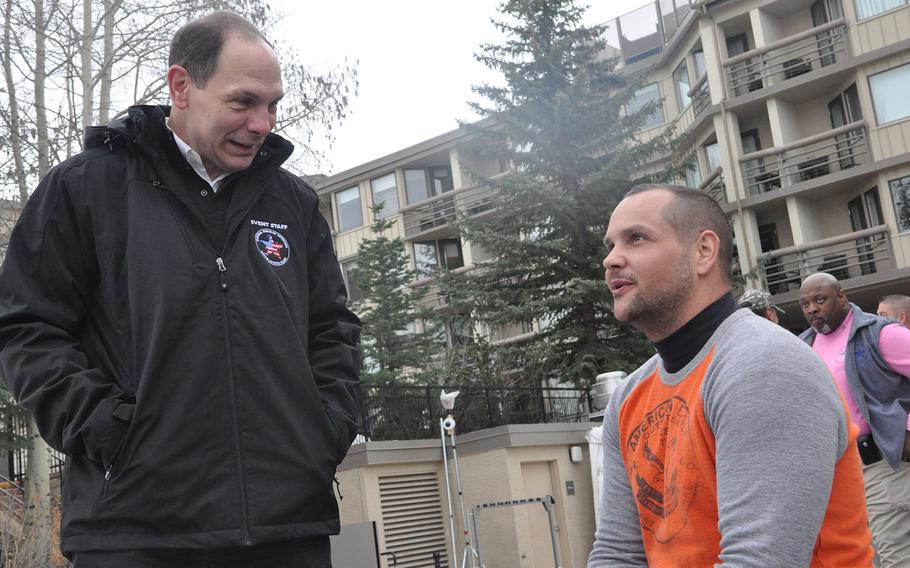 Secretary of Veterans Affairs Bob McDonald, left, speaks to a veteran Thursday, April 2, 2015, at the National Disabled Veterans Winter Sports Clinic in Snowmass Village, Colo.