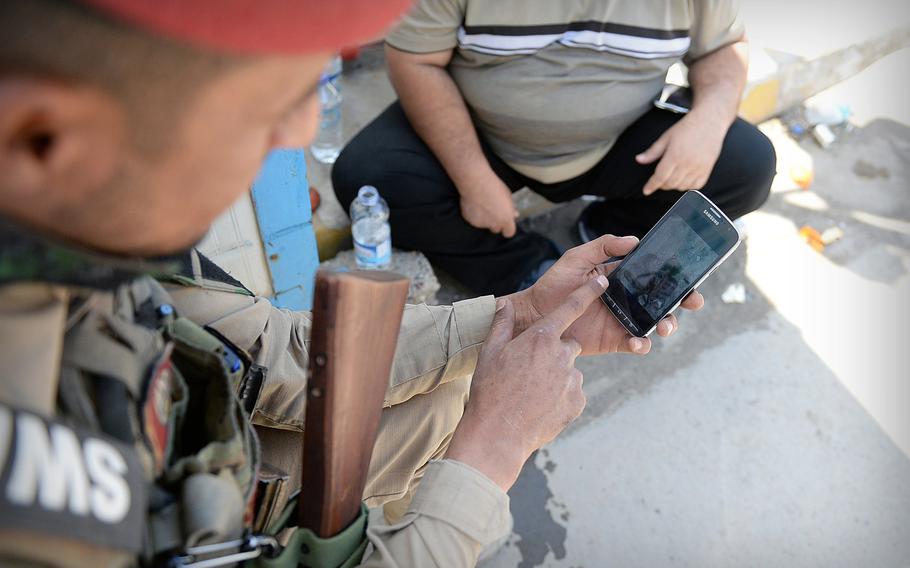 Ahmed, a young member of Tikrit's police force, displays graphic photos of Islamic State fighters he claimed to have killed, and in some cases, decapitated. He said Islamic State killed many members of his family and still holds his wife and children hostage.
