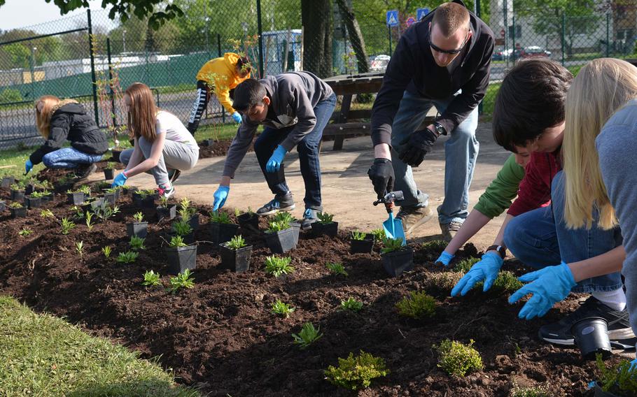 Wiesbaden Middle School students plant flowers, herbs and bushes in a bed next to the school Wednesday, April 29, 2015. The school is one of two Department of Defense Education Activity schools to be named a Green Ribbon School this year.