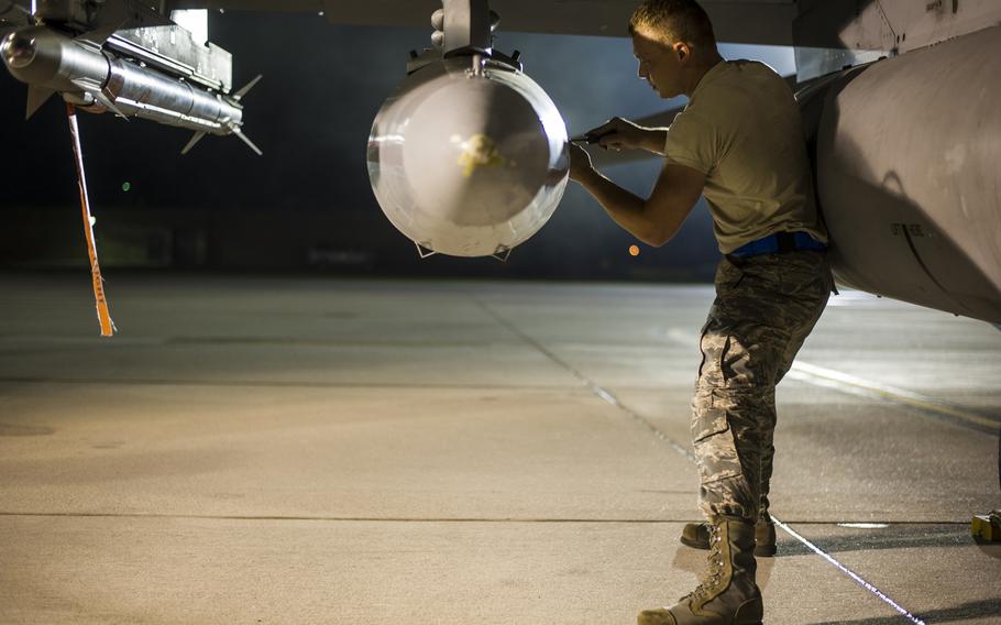 Senior Airman Aaron Carbaugh from the South Carolina Air National Guard?s 169th Fighter Wing at McEntire Joint National Guard Base, S.C., closes the latch to a storage pod on an F-16 Block 52 Fighting Falcon before its departure in support of Operation Atlantic Resolve in Poland, May 28, 2015.