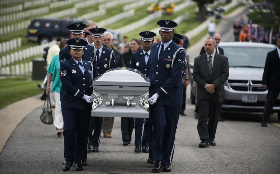 Members of Scott Air Force Base Honor Guard transfer Tech. Sgt. Louis Clever to his final resting place May 22, 2015, at Jefferson Barracks National Cemetery, St. Louis. Clever passed away in 1969, when his plane went down. His son, Paul, traveled to Laos to recover his remains.