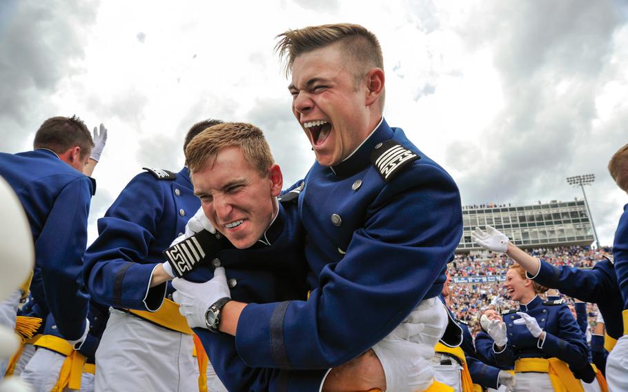 The U.S. Air Force Academy Class of 2015 celebrates after sending their hats skyward as the U.S. Air Force Thunderbirds roared over Falcon Stadium in Colorado Springs, Colo., May 28, 2015. More than 800 cadets graduated and became second lieutenants.