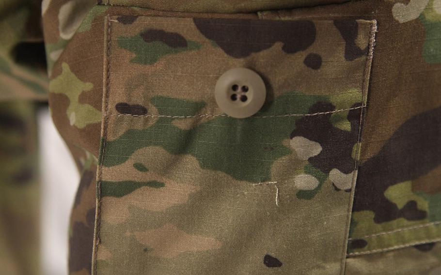 The hook and loop has been replaced by a button on the lower leg pocket flap.
