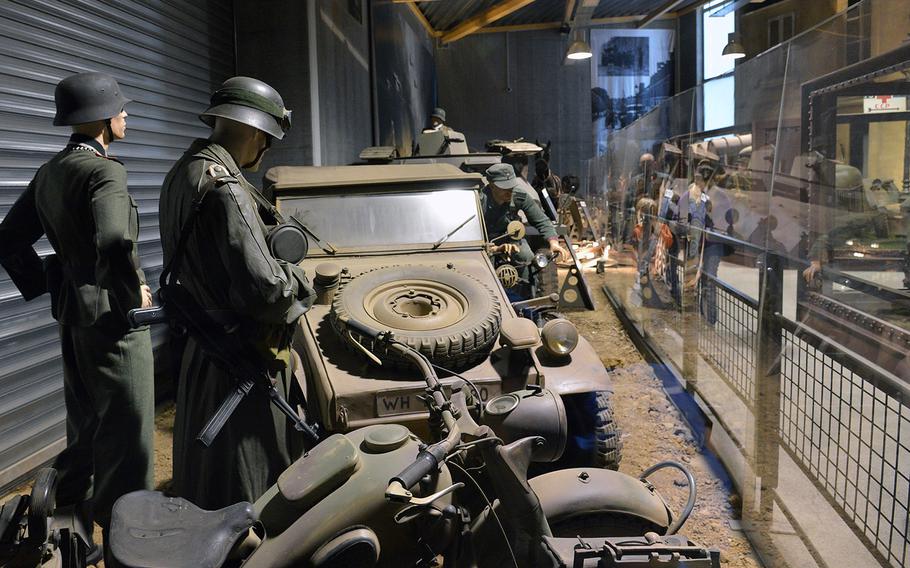 A display at the Overlord Museum in Colleville-sur-Mer, France, depicts German soldiers standing around a Kuebelwagen, a jeep-like vehicle made by Volkswagen.
