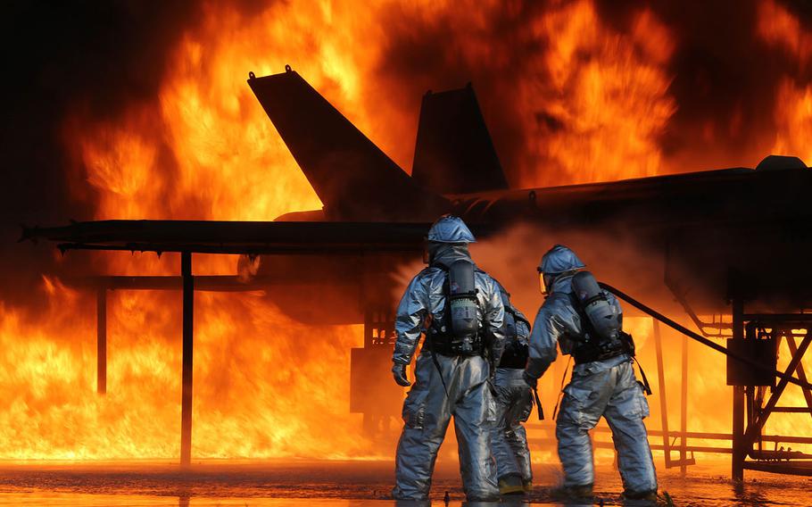 Marines battle a blaze as part of monthly training to ensure they are always prepared in the event of an emergency on the flight line at Marine Corps Air Station Beaufort, S.C., on May 28, 2015.