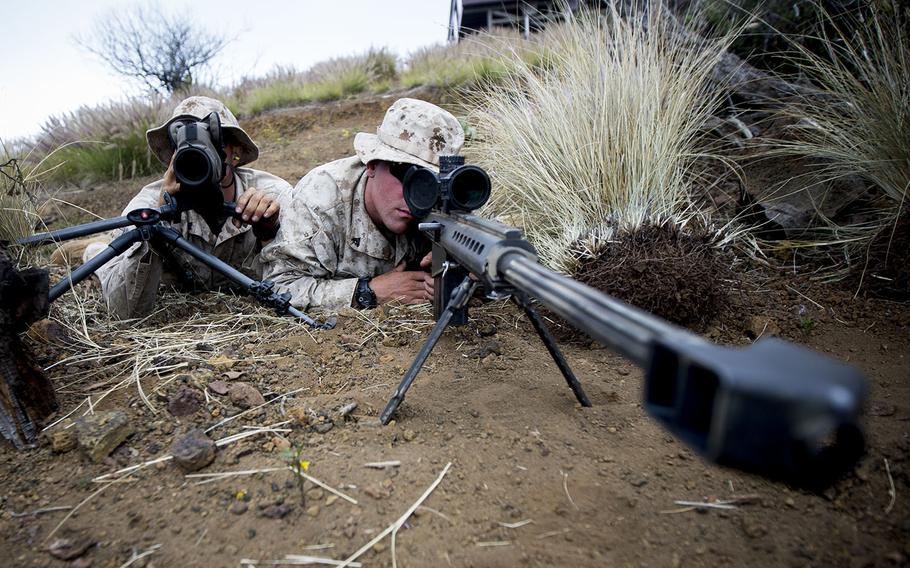 U.S. Marines attached to Scout Sniper Platoon, Weapons Company, 1st Battalion, 3rd Marine Regiment pose as a sniper spotter team with the M107 .50-caliber sniper rifle at Pohakuloa Training Area, Hawaii, June 3, 2015.