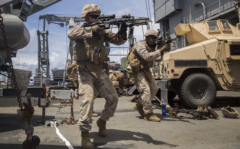 Lance Cpl. Trent Martin, left, and Cpl. Heath Crouch rehearse urban operation tactics aboard USS Rushmore at sea in the Pacific Ocean, June 1, 2015.