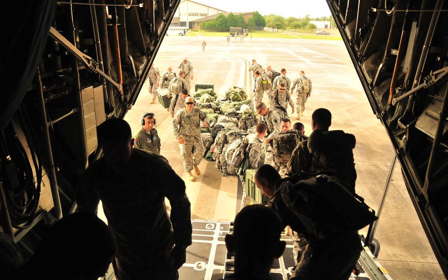 Shortly after arrival at Self Airfield in Fort Polk, La., soldiers from the 296th Infantry Battalion of the Puerto Rico National Guard unload their gear from a C-130 Hercules aircraft to continue their training at Fort Polk.