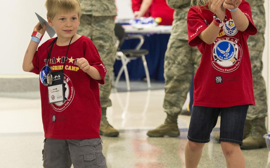 Kids get ready to launch their paper airplanes during a 21st Annual Tragedy Assistance Program for Survivors seminar and Good Grief Camp for Young Survivors event at the Pentagon in Washington, D.C., May 22, 2015.