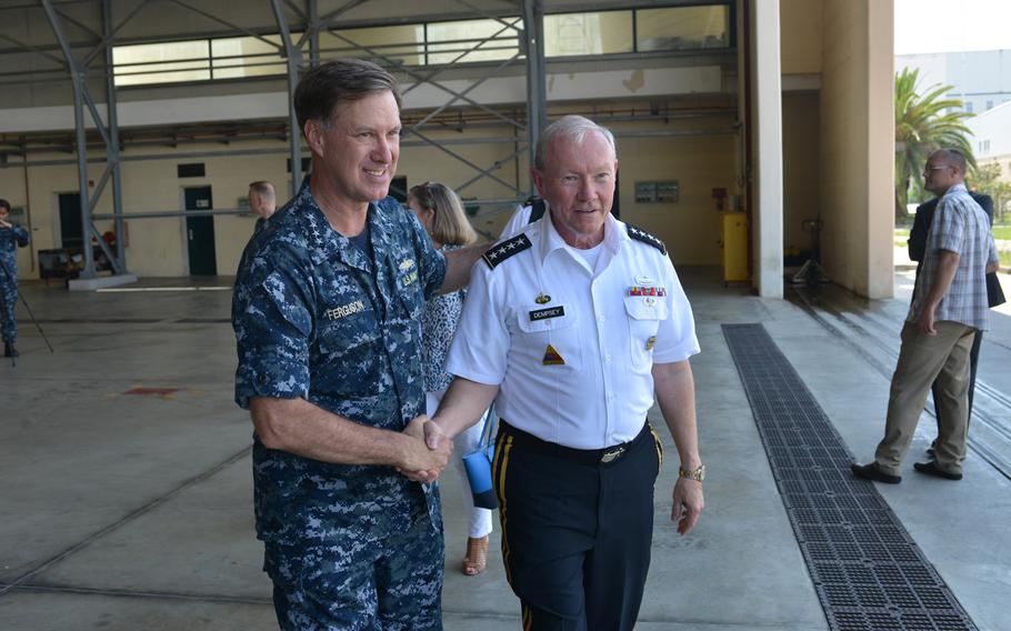 Adm. Mark Ferguson, left, commander of U.S. Naval Forces Europe-Africa, says goodbye to Gen. Martin Dempsey, chairman of the Joint Chiefs of Staff, following Dempsey's remarks to an audience of sailors at the Navy base in Naples, Italy, on June 11, 2015.