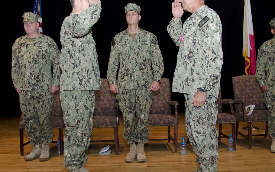 Capt. Cory R. Howes, left, took over from Capt. David J. Meron, right, as commanding officer of Naval Support Activity Bahrain on Thursday, June 11, 2015.