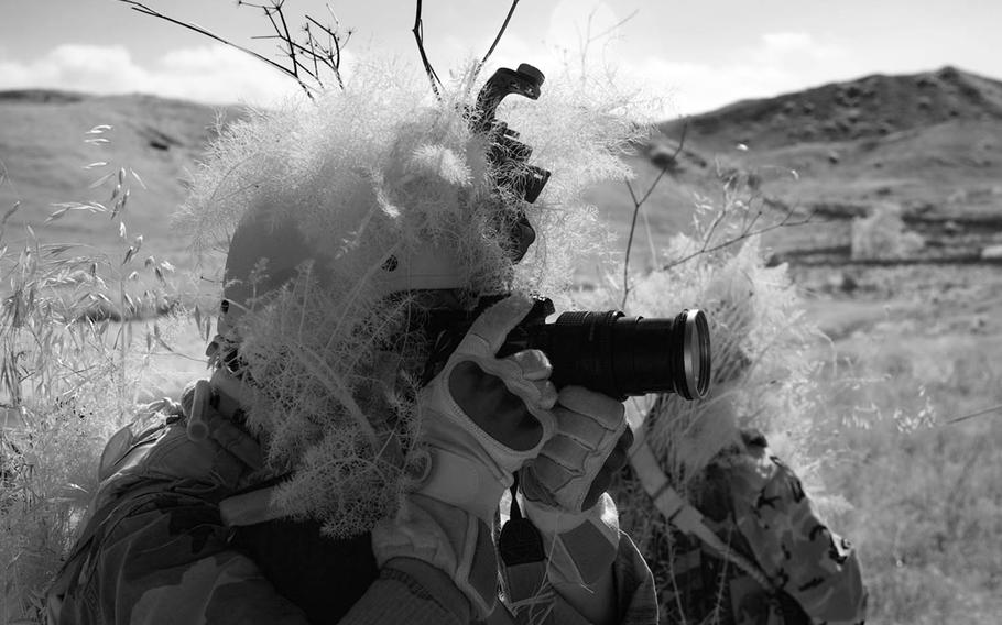 U.S. Navy Mass Communication Specialist 2nd Class Alex Diaz, assigned to Fleet Combat Camera Group Reserve, photographs a training scenario during Exercise Quickshot 2009 at Camp Pendleton, Calif., May 12, 2009. There are 700 active-duty troops and more than 240 reserve personnel assigned to combat camera units in the Army, Navy and Air Force or spread throughout other units in the Marine Corps.
                
