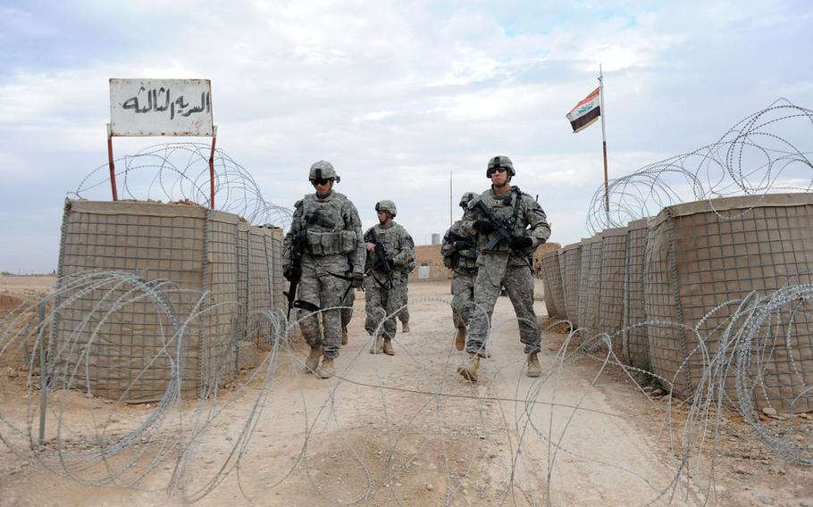 Soldiers from 3rd Platoon, Charlie Company, 1st Battalion, 8th Cavalry Regiment, leave an Iraqi army outpost to conduct a weapons cache search with the Iraqi Army's 4th Battalion, 47th Brigade, 12th Division, near the village of Al Najatia, Kirkuk, Iraq, Dec. 5, 2009, in this photo taken by a combat camera photographer. More than 700 active-duty troops belong to the military speciality.
                