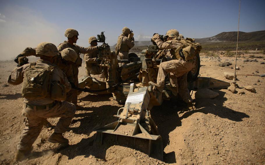 In this combat camera photo, U.S. Marines with the 13th Marine Expeditionary Unit Battalion Landing Team 1/4 prepare to fire the M777 Howitzer during a battery defense battle drill in Arta, Djibouti, Nov. 3, 2013. Five combat camera members have lost their lives performing their mission in recent years.
                