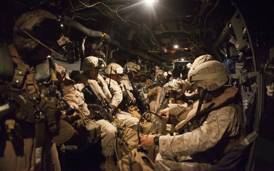 In this combat camera image, a quick reaction force with Special-Purpose Marine Air-Ground Task Force Crisis Response prepares to depart Naval Air Station Sigonella, Italy, in support of a military assisted departure from the U.S. Embassy in Tripoli, Libya, Saturday, July 26, 2014. 