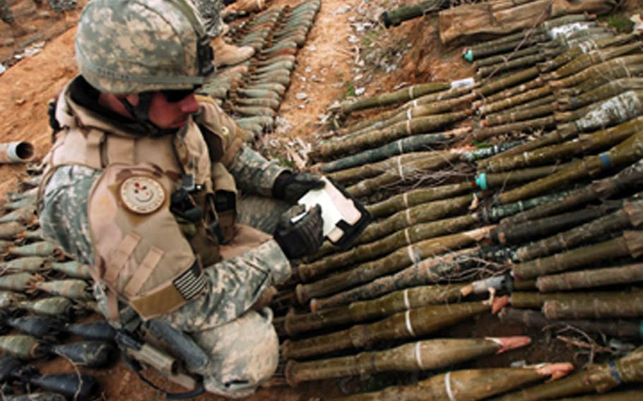 Air Force Senior Airman Gabriel Barnes, 1st Brigade, 1st Battalion, 327th Infantry, 101st Airborne Division, inventories a large weapons cache found on the outskirts of Hawija, Iraq, during a joint mission led by the Iraqi Army, in this combat camera photo. Combat camera members receive training in aerial, underwater, night-vision and low-light photography and videography
                
