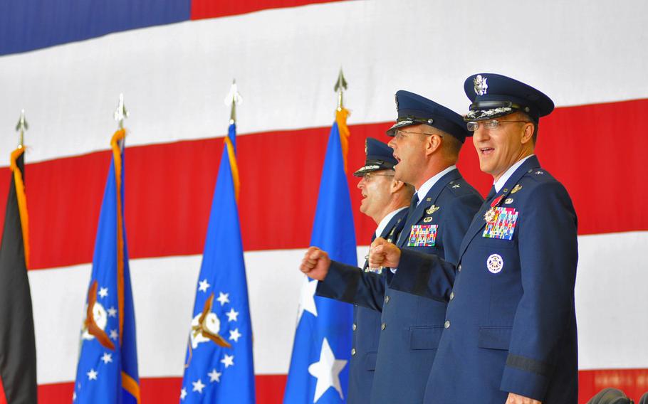 From left, 3rd Air Force Commander Lt. Gen. Darryl L. Roberson sings the Air Force song with Brig. Gen. Jon T. "Ty" Thomas, and Brig. Gen. Patrick X. Mordente at the end of the 86th Airlift Wing change-of-command ceremony on June 19, 2015, at Ramstein Air Base, Germany. Mordente, the outgoing commander, is headed to Scott Air Force Base, Ill., where he'll be the vice commander of 18th Air Force, Air Mobility Command. Thomas is the new wing commander at Ramstein.