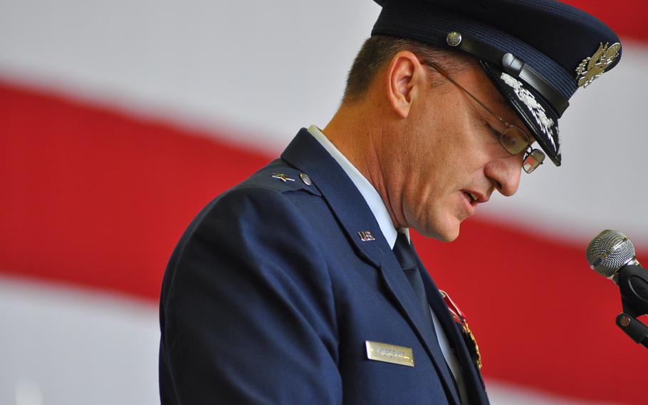 Outgoing commander Brig. Gen. Patrick X. Mordente looks down while speaking during the 86th Airlift Wing change-of-command ceremony on June 19, 2015, at Ramstein Air Base, Germany. 
