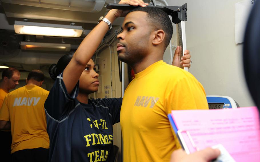 Petty Officer 3rd Class Britani Parker conducts a body composition assessment during a physical readiness test aboard the aircraft carrier USS Theodore Roosevelt on May 14, 2015. The Navy is considering changes to its fitness program, particularly how it deals with sailors of fail their body composition assessment.