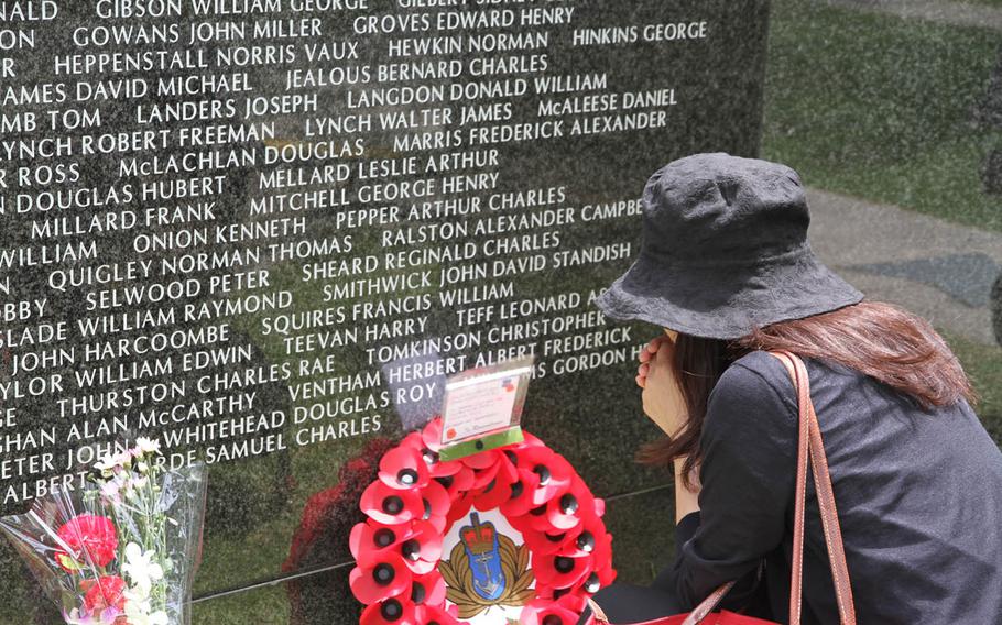 A young Japanese woman pauses to admire a wreath laid by Mike Stevens and his twin sister Marjorie at Tuesday's annual Irei no Hi ceremony at Okinawa Peace Memorial Park commemorating the 70th anniversary of the pivotal World War II Battle of Okinawa. The Stevens family laid the wreath on behalf of all the British servicemembers who served and gave their lives in the battle. 