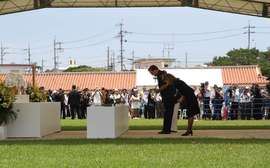 Ambassador to Japan Caroline Kennedy and the American delegation bow before an altar honoring approximately 200,000 who died in the Battle of Okinawa at Tuesday's Irei no Hi ceremony commemorating the 70th anniversary of the pivotal World War II battle. The event was more contentious than in previous years as protesters against a new U.S. military runway in northern Okinawa descended on the event in an attempt to send a message to Tokyo. 