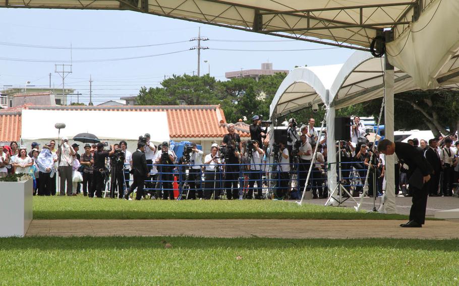 Okinawa Gov. Takeshi Onaga bows for the victims of the Battle of Okinawa Tuesday during a ceremony commemorating the battle's 70th anniversary. Onaga used the ceremony as a platform to lash out at Japanese Prime Minister Shinzo Abe for pushing ahead with a new U.S. military runway in Okinawa's remote north, much to the dismay of families who lost loved ones in the conflict. 
