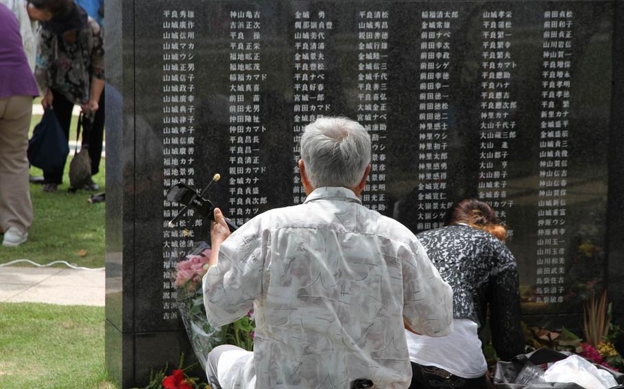 An Okinawan man plays traditional songs for family members lost during the war at Tuesday's Irei no Hi ceremony commemorating the 70th anniversary of the Battle of Okinawa. 