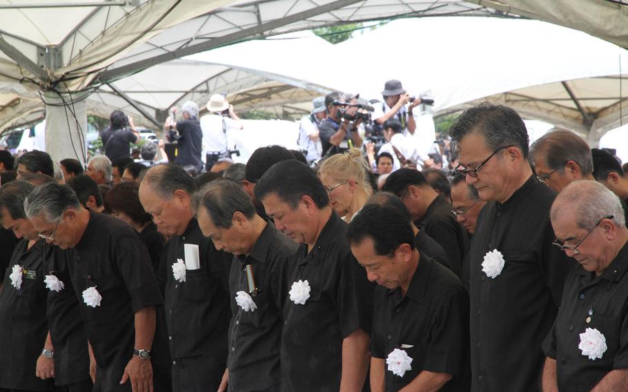 Attendees bow their heads for a moment of silence during Tuesday's annual Irei no Hi ceremony at Okinawa Peace Memorial Park. This year's ceremony drew veterans and dignitaries and commemorated the 70th anniversary of the Battle of Okinawa. 
