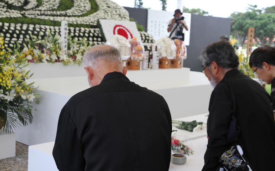 People line up Tuesday to pay their respects for the approximately 200,000 civilian and military personnel who lost their lives in the Battle of Okinawa. Over 5,000 people attended the ceremony to commemorate the 70th anniversary of the World War II battle. 