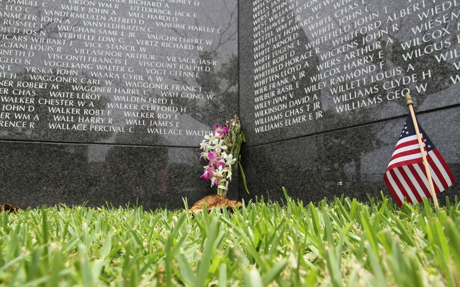 Flowers and a note honoring an unknown American servicemember killed in the Battle of Okinawa were placed with care at the base of his memorial plaque Tuesday. Four American veterans of the battle attended this year's ceremony. None attended last year. 