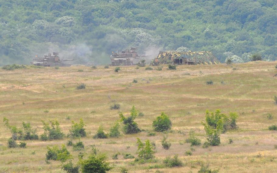 Two U.S. Army M1A2 Abrams tanks begin to fire their guns during a live-fire exercise that closed the Kabile 2015 tactical exercise at Novo Selo Training Area, Bulgaria, on Thursday June 25, 2015. About 50 U.S. Army troops from 3rd Combined Arms Battalion, 69th Armor Regiment and 2nd Squadron, 2nd Cavalry Regiment took part in the demonstration. The tanks were transported to Bulgaria aboard a U.S. Air Force C-17 aircraft.