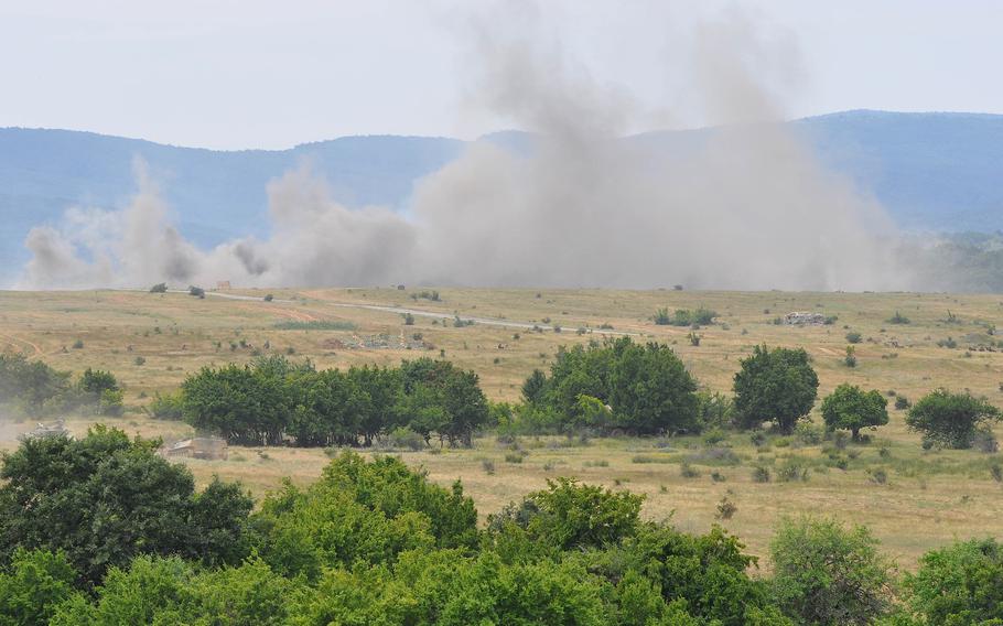The target area of the Novo Selo Training Area erupts in smoke and dust after being pounded by two U.S. Army M1A1 Abrams tanks and three Bulgarian army T-72 tanks during a live-fire exercise that closed the Kabile 2015 tactical exercise at Novo Selo Training Area, Bulgaria, on Thursday June 25, 2015.