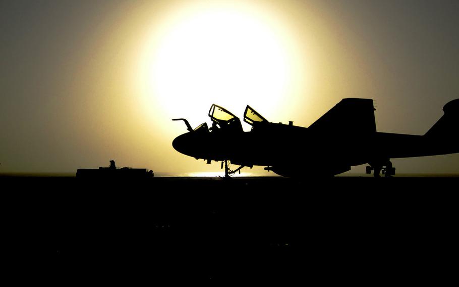 An EA-6B Prowler assigned to the ''Zappers'' of Electronic Attack Squadron 130 is towed across the flight deck of the aircraft carrier USS Harry S. Truman after completing flight operations August 1, 2010.