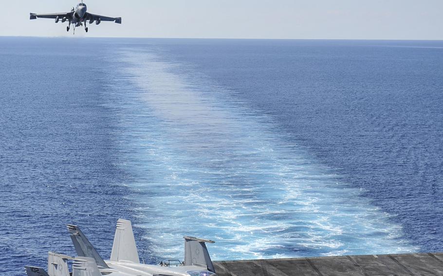 An EA-6B Prowler assigned to the ''Gray Wolves'' of Electronic Attack Squadron 142 prepares to land on the flight deck of the aircraft carrier USS Nimitz on October 26, 2013.