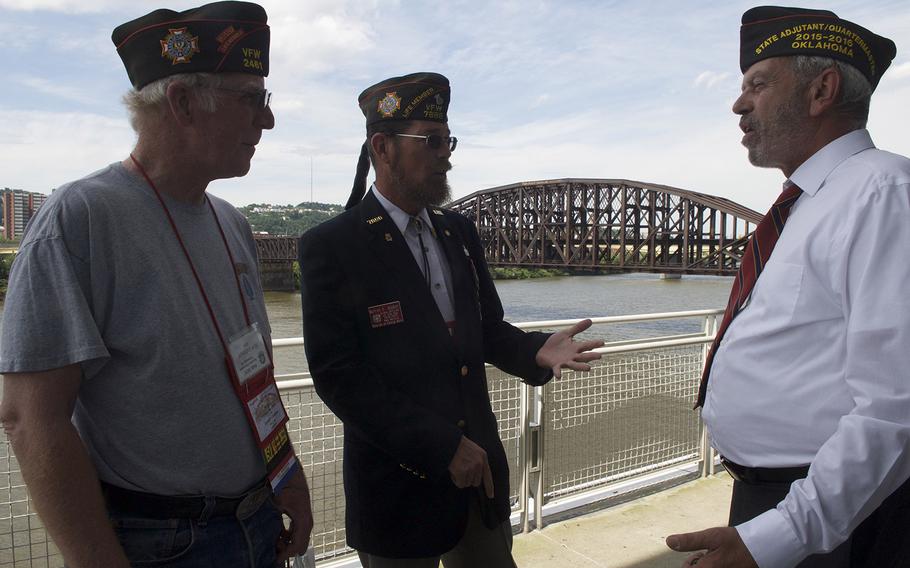 Veterans talk on a riverside patio of the David L. Lawrence Convention Center in Pittsburgh on Monday, July 20, 2015, at the Veterans of Foreign Wars National Convention, where President Barack Obama spoke a day later. Those in attendance gave mixed reviews of Obama's record on veterans' issues.