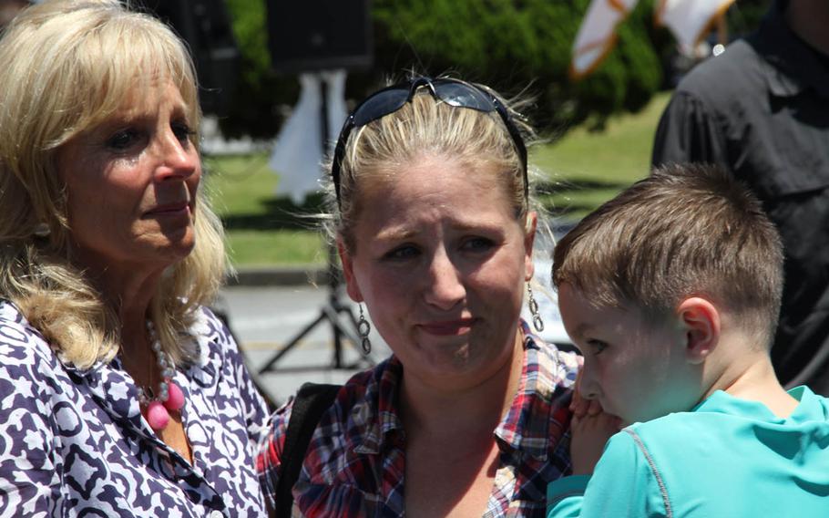 Jill Biden, wife of Vice President Joe Biden, left, sheds a tear with Maureen Rosenblatt, holding her son Nathaniel, July 23, 2015, at Kadena Air Base in Okinawa, Japan. Biden stopped by the base in support of her and first lady Michelle Obama's Joining Forces initiative to support servicemembers, veterans and their families.