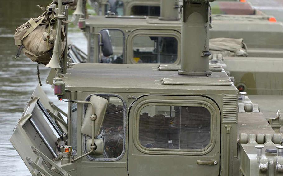 Six M3 Amphibious Rigs, three British and three German, span a bridge across the Weser River on the outskirts of Petershagen, Germany, Tuesday, July 28, 2015.