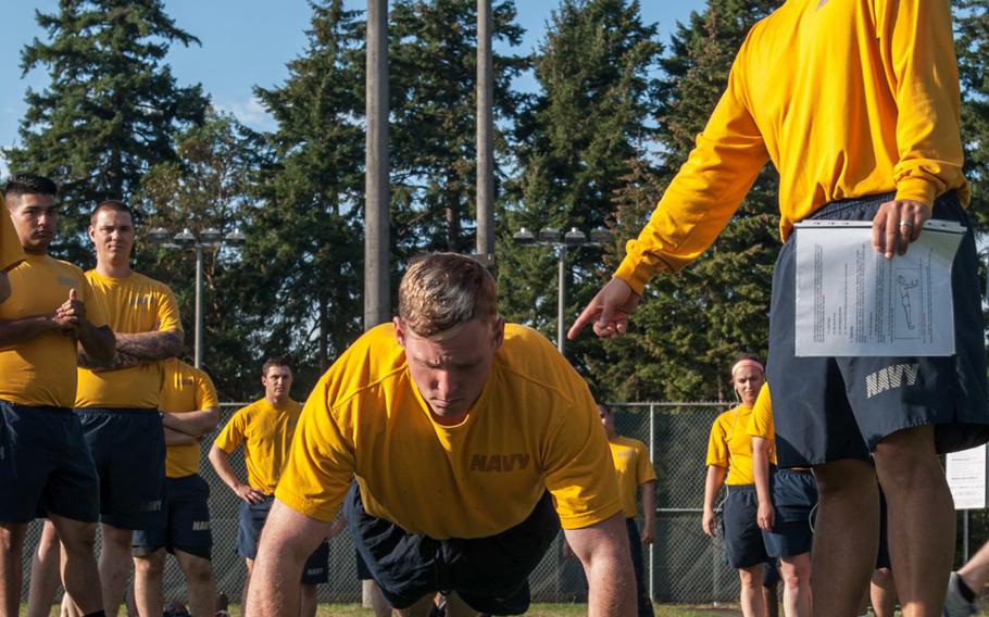 Petty Officer 2nd Class James Hiatt, from Kansas City, Mo., demonstrates the pushup portion of a physical fitness assessment in this Navy photo from 2014. New changes to the assessment to take effect in 2016 will emphasize the exercise portion of the test and relax body weight standards.