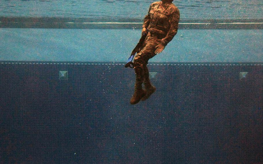 A security forces airman plunges into the water as part of a survival test at the U.S. Air Force Academy, Colo., on Friday, July 17, 2015. The event was part of a one-day course for airmen to determine if fitness to attend the U.S. Army Pre-Ranger Training Assessment Course.