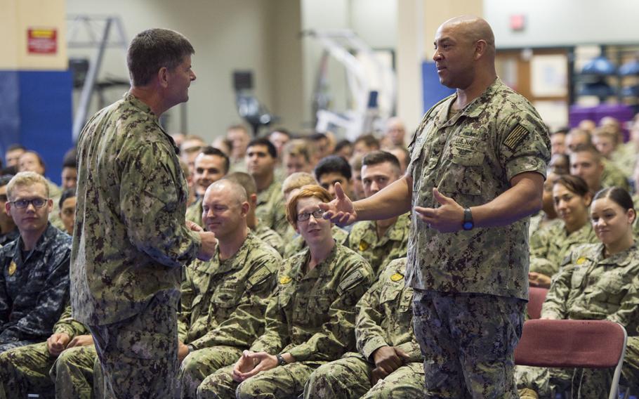 Petty Officer 1st Class Nicholas Perez, a culinary specialist working at Naval Support Activity Bahrain, right, asks Vice Adm. Bill Moran, Chief of Naval Personnel, about new changes to the Navy's body composition assessment during an all hands call Wednesday, Sept. 9, 2015.